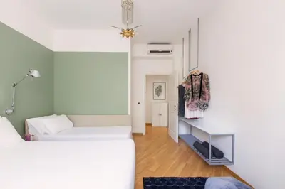 a small bedroom with two beds and a desk at ROMAC Gianicolo 3-Bedroom Holiday Apartment in Rome