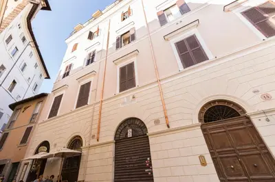 a large white building with a brown door at ROMAC Coronari with gym, sauna and garden in Rome