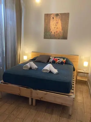 a bedroom with a bed with two towels on it at Old Bakery Rome Suites & Apartments in Rome