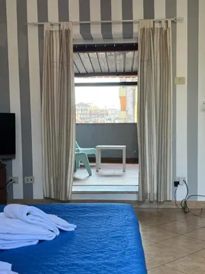 a bedroom with a bed and a view of a patio at Old Bakery Rome Suites & Apartments in Rome