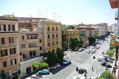a city street with cars parked on the street at Beautiful apartment in San Giovanni close to Colosseo in Rome