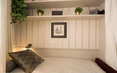 a bedroom with a bed and shelves with plants at Roma Fontana di Trevi in Rome