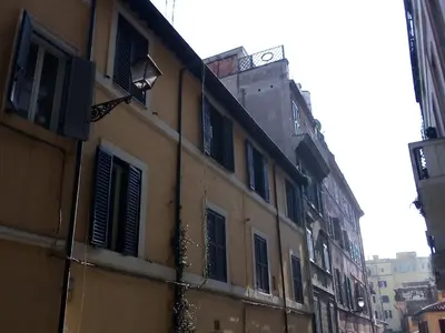 a building with a clock tower on top of it at Apartment Rome & More in Rome