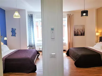 a bedroom with two beds in a room at Sonny Capone Al Vaticano in Rome