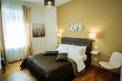 a bedroom with a bed and a chair in it at Sonny Capone Al Vaticano in Rome