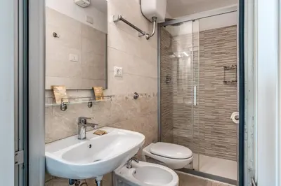 a bathroom with a sink and a toilet and a shower at Hotel Katty in Rome