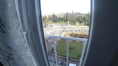 a view of a street from a window at Colosseo Rooms Imperial Rome in Rome