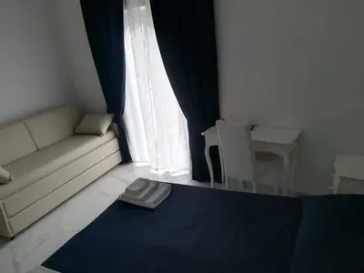 a living room with a couch and a window at Colosseo Rooms Imperial Rome in Rome