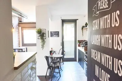 a kitchen and dining room with a table and chairs at co.sleep in Rome