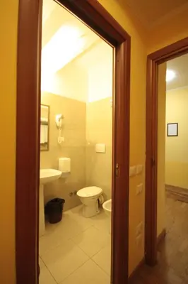 a bathroom with a toilet and a sink at Hotel Termini in Rome