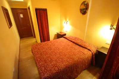 a bedroom with a red bed in a room at Hotel Termini in Rome