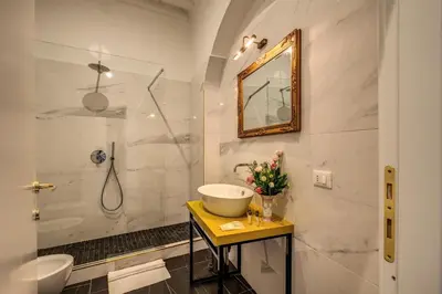 a bathroom with a sink and a shower at Little Queen Pantheon in Rome