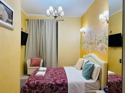 a bedroom with a bed and a chandelier at Rome Innitaly Affittacamere o GuestHouse in Rome