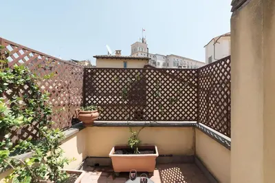 a balcony with a potted plant on a fence at Trevi's Roof Terraces in Rome