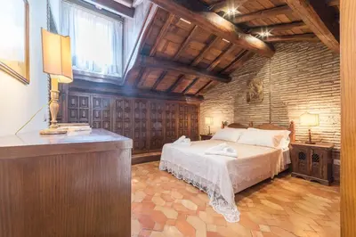 a bedroom with a bed in a room with a window at Trevi's Roof Terraces in Rome