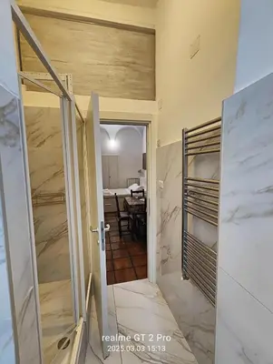 a room with a door open to a room with a table at NAVONA & CASTEL SANT'ANGELO WHOLE HOLIDAY APARTMENT da PAMINO & PRISCILLA in Rome