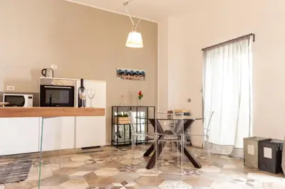 a living room with a table and a kitchen at Elegant Apartment in the Center of Rome! in Rome