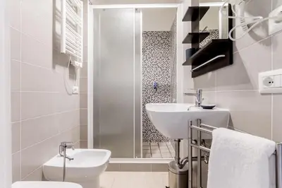 a bathroom with a toilet sink and a shower at MARCONI 94 - APARTMENT&PRIVATE ROOMS in Rome