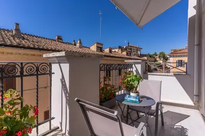 a balcony with a table and chairs on a building at Relais Trevi 95 Boutique Hotel in Rome