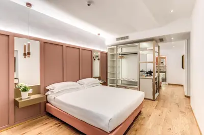 a bedroom with a large white bed in a room at Relais Trevi 95 Boutique Hotel in Rome