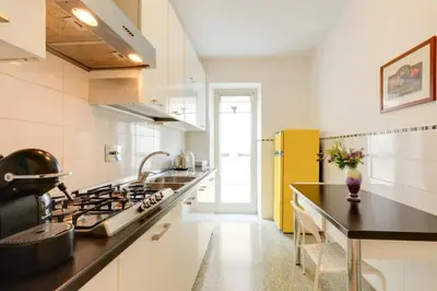 a kitchen with a stove and a yellow refrigerator at Roman Style I near San Pietro in Rome