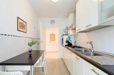 a white kitchen with a sink and a counter at Roman Style I near San Pietro in Rome