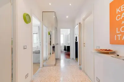 a hallway with white walls and a mirror at Roman Style I near San Pietro in Rome