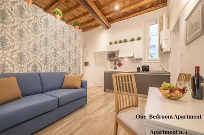 a living room with a blue couch and a table at CS Exclusive Campo de Fiori Palace in Rome