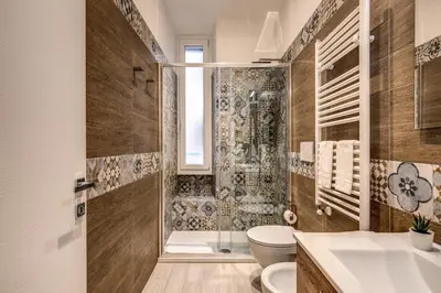 a bathroom with a shower and a toilet and a sink at Vatican Royal Apartment in Rome
