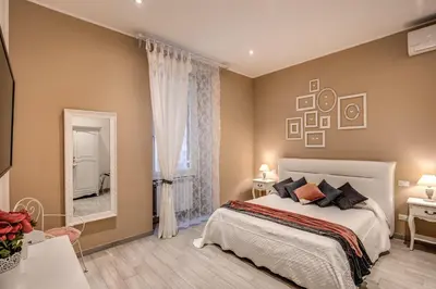 a bedroom with a bed and a large mirror at Vatican Royal Apartment in Rome