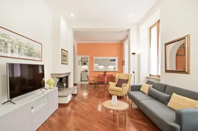 a living room with a couch and a tv at BDC - Colosseum Superior Apartment in Rome