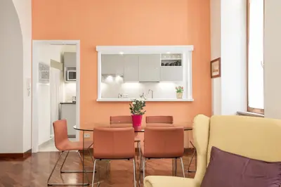 a dining room with a table and chairs at BDC - Colosseum Superior Apartment in Rome
