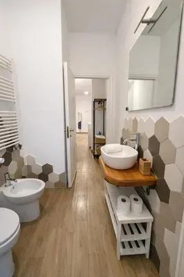 a bathroom with two sinks and two toilets at Qflat Aura Paradise Vatican with parking garage in Rome