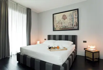 a hotel room with a bed with a tray of food on it at Suite Art Navona in Rome