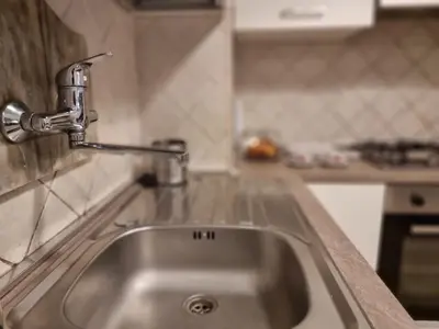 a kitchen sink with a faucet on a counter at Pantheon, Campo de fiori mini garden in Rome