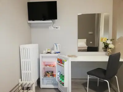 a room with a desk and a mirror at Garden's Elide in Rome