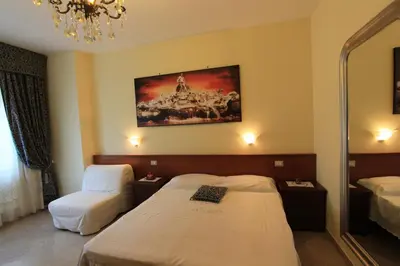 a hotel room with a bed and a mirror at Le Terrazze Del Vaticano in Rome