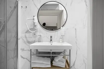 a white bathroom with a sink and a mirror at Gh Trevi Fountain in Rome