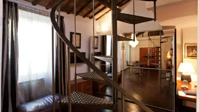 a room with a spiral staircase in a room at Rental in Rome Loft Cappellari in Rome