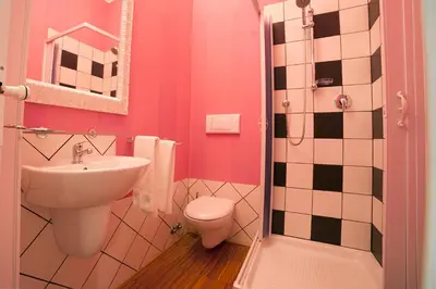 a bathroom with a toilet and a sink at Ostiense Suites in Rome