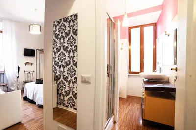 a bathroom with a sink and a toilet in a room at Ostiense Suites in Rome