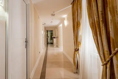 a hallway with a door and a long hallway at Demetra Hotel in Rome