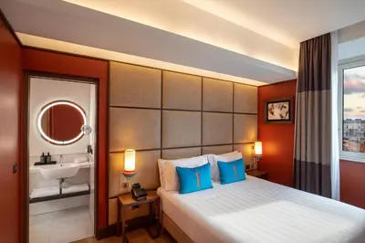 a hotel room with a bed and a sink at The Independent Hotel in Rome