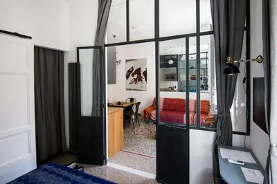 a room with a door open to a room with a desk at Appart in Rome