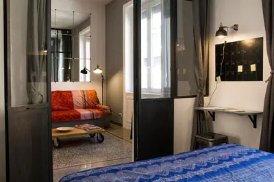 a room with a bed and a couch and a mirror at Appart in Rome