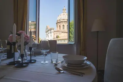 a dining room table with a view of a building at Leonardo Suite Navona in Rome