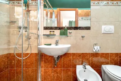 a bathroom with a sink and a shower at Colosseo Relais in Rome