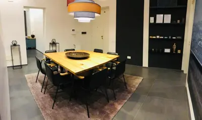 a dining room with a wooden table and black chairs at STAY FINE Holiday’s House in Rome