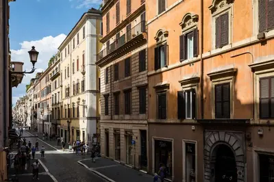 a city street with buildings and people walking on the street at Elysium Suites collection in Rome