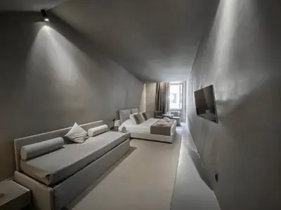 a living room with a couch and a tv at Elysium Suites collection in Rome